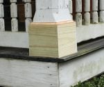 Porch column base with new unpainted pressure treated base trim boards..