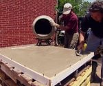 Pouring concrete in the form for a concrete countertop.