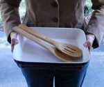 Woman holding empty casserole dish