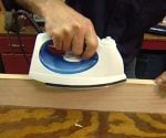 Using a clothes iron to attach edge banding veneer to a plywood edge
