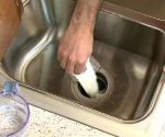 Using baking soda to clean a garbage disposal.