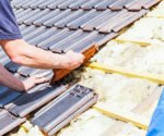 a roofer laying tile on the roof